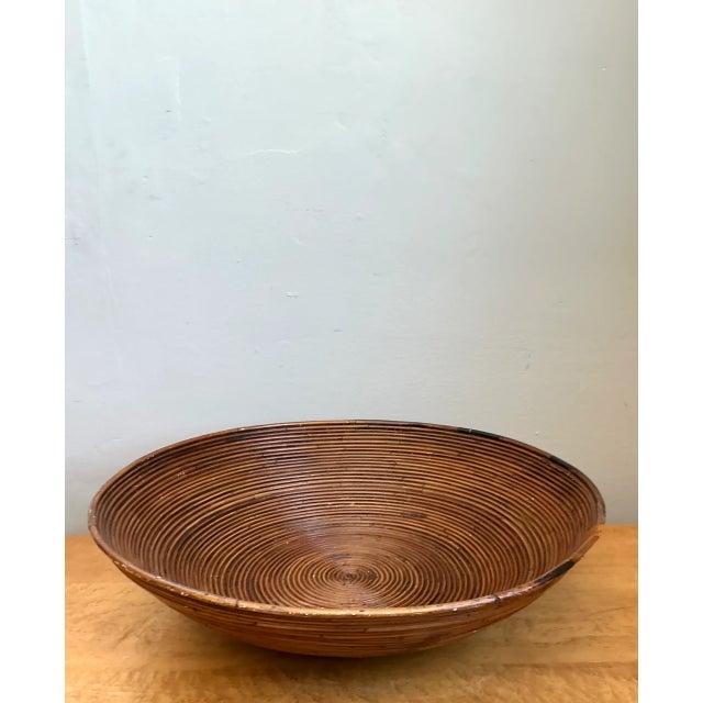 Constructed with finely wrapped natural pencil reed in an expansive 20-inch round silhouette, this vintage decorative...
