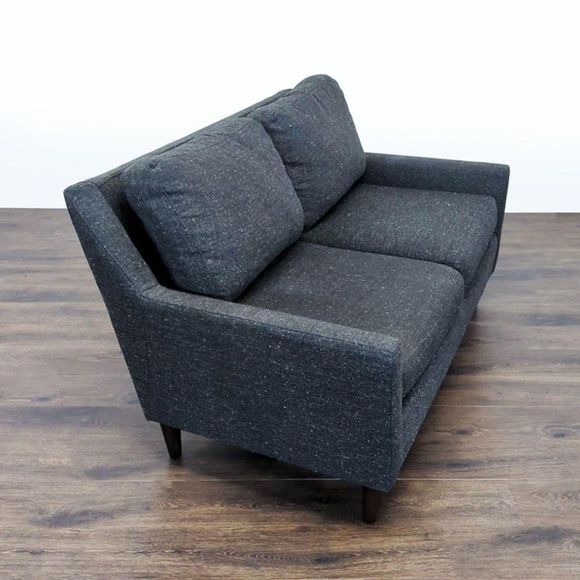 Features sleek design with fabric upholstery and wood legs. Brand: West Elm. Original Price: $800. Dimensions (in): 60W x...