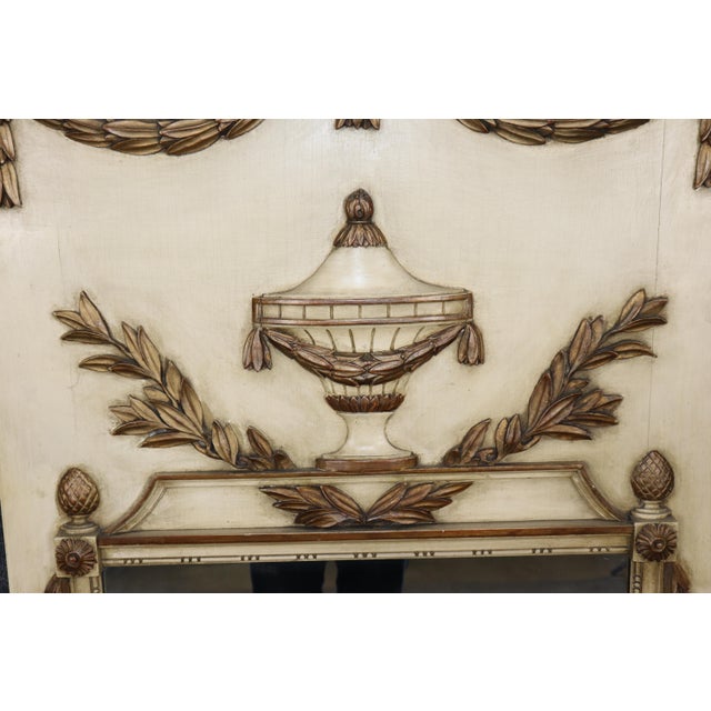 An exceptionally decorative French trumeau mirror dating to the 1960s–1970s, beautifully executed in the Louis XVI...