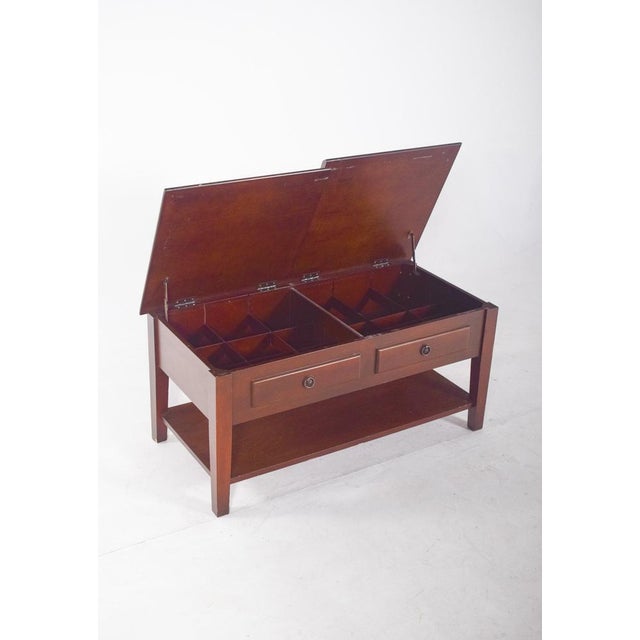 Coffee table, with hinged top. with a robust rectangular structure and a simple but elegant finish, the top is divided...