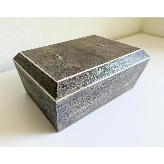 A large shagreen jewelry box by R & Y Augousti. It features an angled, multi-tiered shape. Handcrafted from genuine...