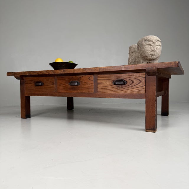 This large Japanese low table from the 1930s is made of solid sugi wood, or Japanese cedar, with a warm honey-brown tone...