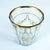 Antique Bohemian gilded glass cup from the 18th century. It has a polygonal shape with 13 sides and a gilded rim, a...