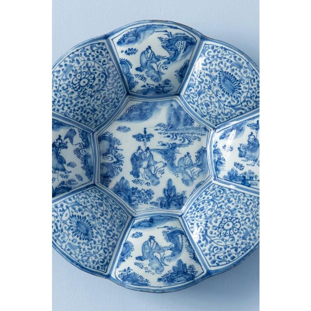 An early 19th-century Dutch Delft dish of exquisite octagonal lobed form, raised on a piedouche. Decorated in blue and...