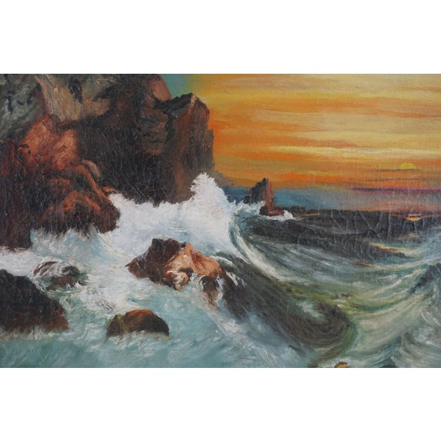 Vibrant antique landscape of a vibrant sunset with rugged waves and rocks in foreground beautifully framing sunset. Circa...