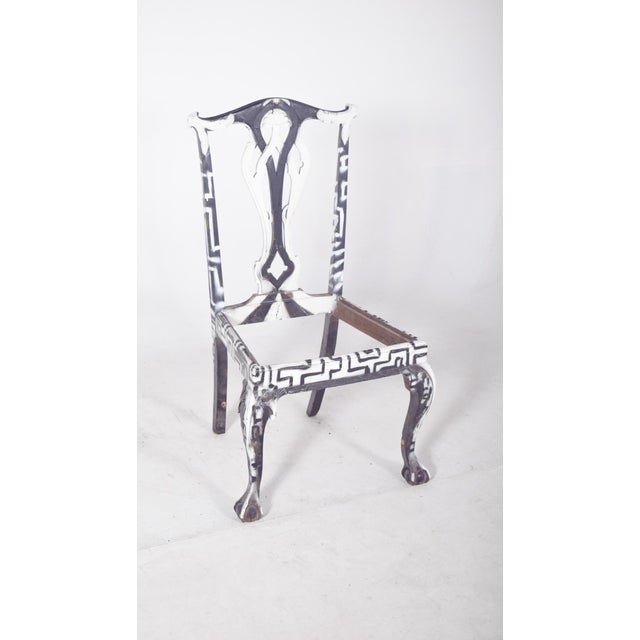 Dining chair painted black and white. Reinterpreted with a contemporary artistic intervention that radically transforms...