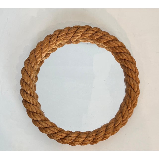 This beautiful round mirror is made entirely of rope surrounding the mirror. It is a French work by Adrien Audoux and...