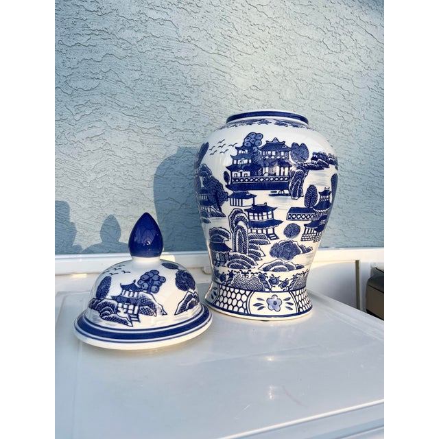 Vintage Asian Ginger Jar. Asian style Lidded porcelain jar. Blue and white with flowers, pagoda, rivers and landscapes...