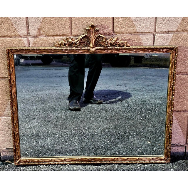 An Early 20th Century Italian Giltwood Ornate Frame Mirror. Measures 32" in width, 28.5" in height, 1.5" in depth.