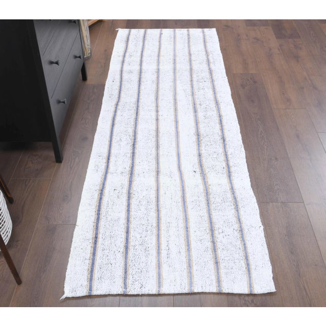 Vintage Turkish Hand-Knotted vintage rug is a semi-Vintage kilim runner rug.'70s Eastern region of Turkey's unique rug is...