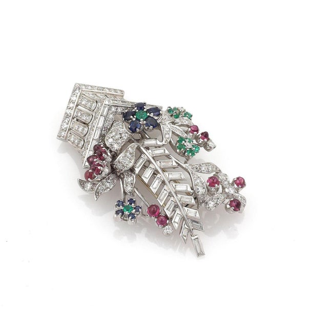 This is a breathtaking flower basket brooch. The piece is exquisitely crafted in platinum with a smooth polished finish...