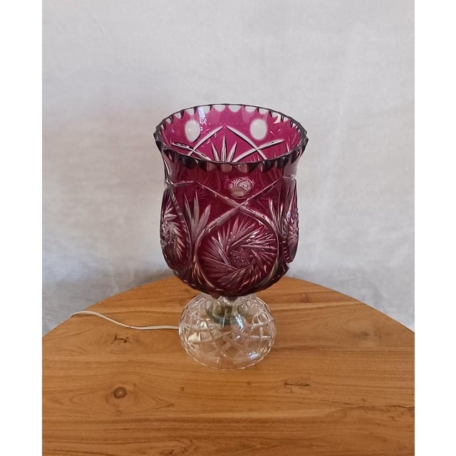Blueberry-colored cut crystal table lamp. Made in England in the 1960s. Uses bayonet-style lamp holders. The lamp consists...