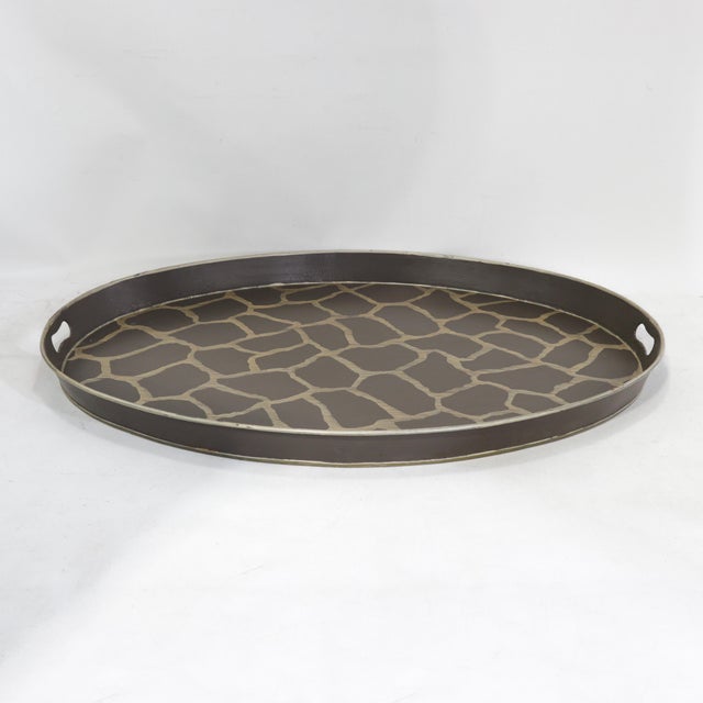 This striking vintage oval tole tray features a bold, hand-painted giraffe animal print pattern in a rich chocolate brown...
