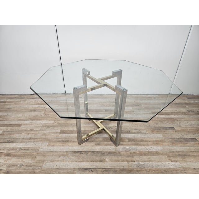 Vintage 1970s table with geometric structure in chromed metal and brass inspired by the Hollywood Regency style which...