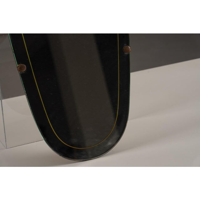 A vintage wall mirror from Germany, 1970's. The producer and designer are unknown. Made from glass with a wooden frame,...