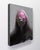 Reflect presents a contemplative figure shrouded in muted greys and deep shadows, with a striking splash of pink across...