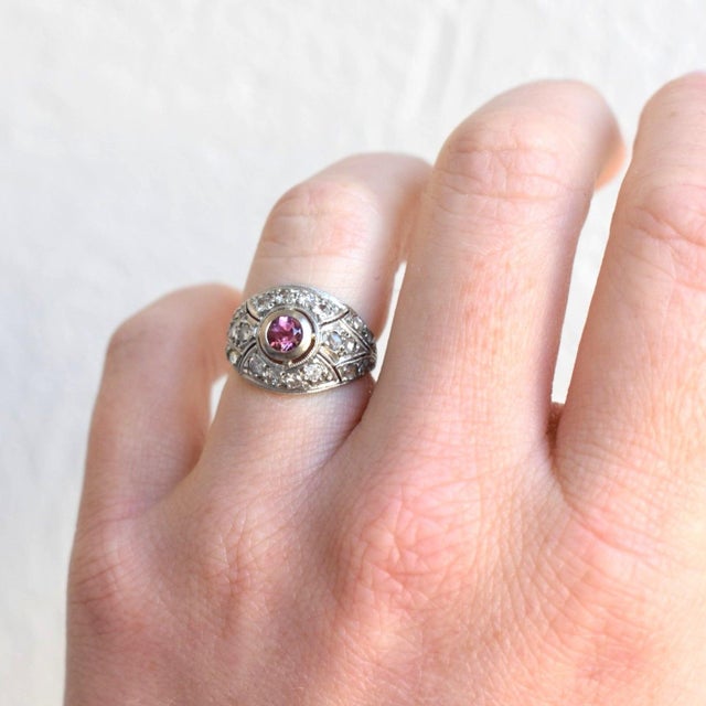 Antique Art Deco ring (circa 1920) masterfully crafted in solid platinum, it is a testament to the era's sophisticated...