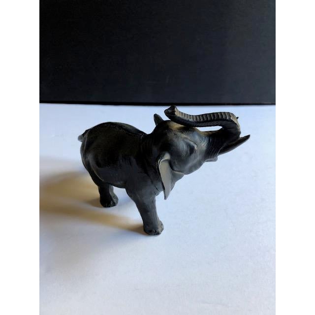 Handsome elephant figurine or paperweight. Made of metal. Signed and numbered on underside.