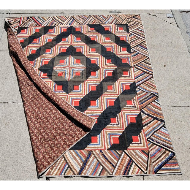 19Thc Wool log cabin quilt or barn raising in fine condition. The backing is in a early brown calico fabric.This was found...