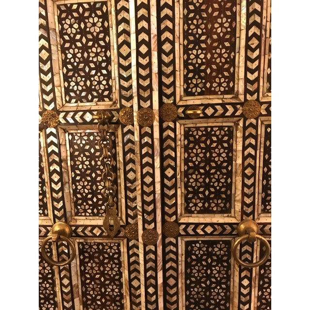 Stunning and wildly gorgeous set of handmade wood doors with abalone inlay throughout. They have a brass chain-and-hoop...