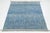 This modern wool rug features a striking interplay of white geometric motifs across a rich blue gradient field. The...