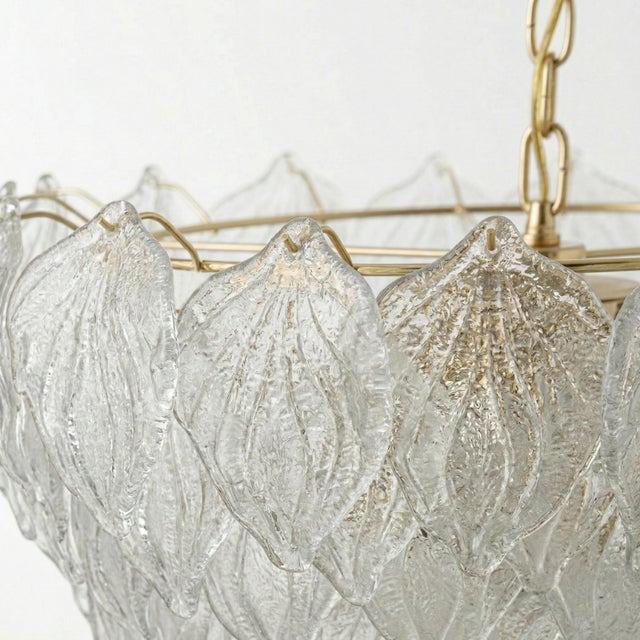 This spectacular light fixture is a tribute to Venetian craftsmanship. It features a six-tiered, concentric structure from...