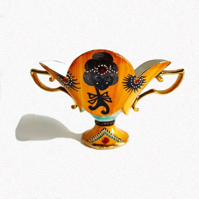 C.A.T., ceramic centerpiece, with two side handles, decoration with enamels and pure gold, h.cm. 17x28x11,5. This piece...