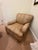 This elegant custom upholstered armchair features a classic rolled‑arm silhouette paired with a richly patterned neutral...