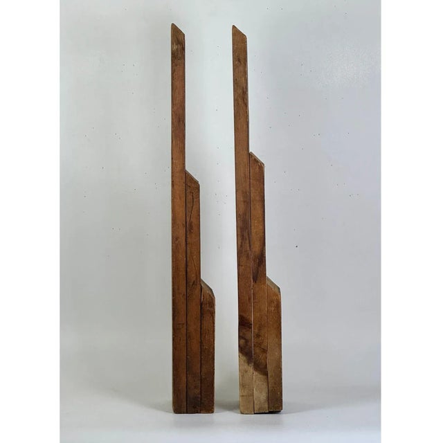 A unique and rare form Mid 20th Century wooden floor sculpture of two towering multi layered and beveled edged planks....
