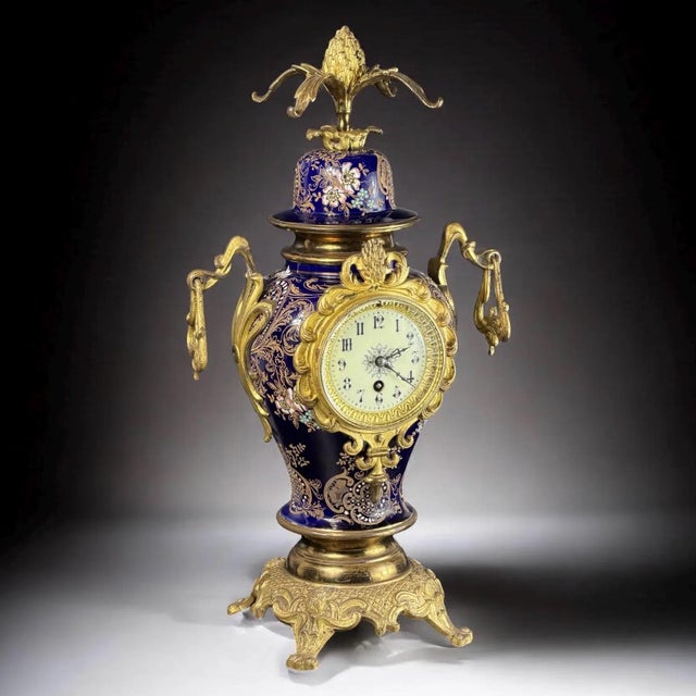 A highly decorative French vase clock executed in cobalt blue porcelain with elaborate gilt bronze mounts, produced in the...