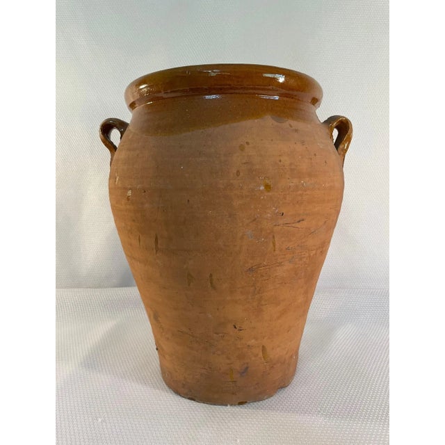 A fabulous large rustic earthenware Olive Jar or Jug with two handles made in Spain. Circa 1890-1900. This handmade and...
