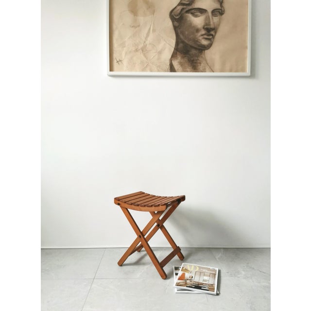 This folding stool, crafted from solid pine, is a minimalist design from the 1950s and was made in Belgium. It is in...