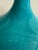 This glazed table lamp has a vibrant turquoise ceramic base with a crackle finish. The drum shade is in a creamy linen....