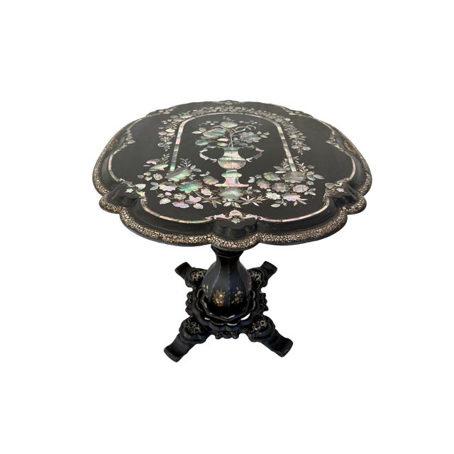 This stunning Victorian ebonized paper-mache tilt-top table features a hand-painted floral motif with intricate mother-of-...