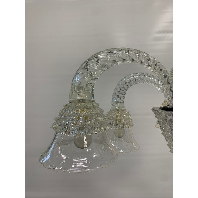 This six-light Murano glass chandelier features a refined design that combines classic elegance and craftsmanship. The...