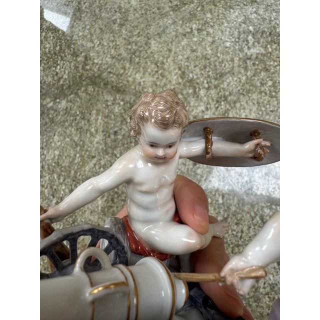 A lovely Meissen figurine of two cherubs with a canon.