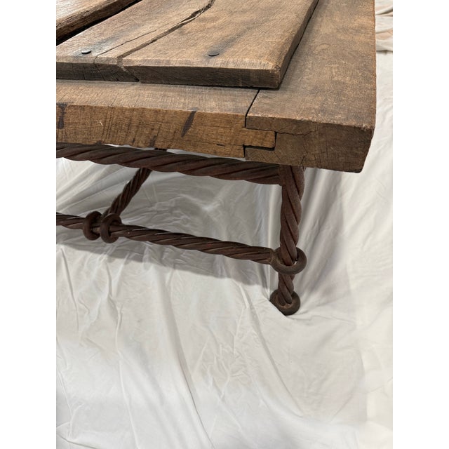 Aged wood coffee table with metal legs. Has old school nails, holes and raised surfaces. Watermarks add to its charm....