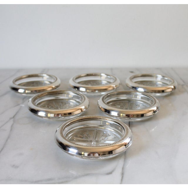 Set of six vintage B. Rogers sterling silver and glass drink coasters. Makers mark on the side of each piece.