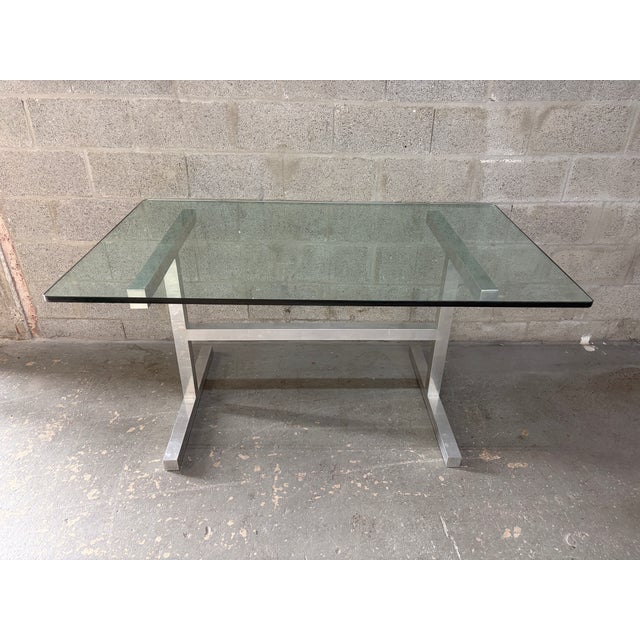 Vintage Mid Century Modern Dining Room Table in the Milo Baughman Style. Circa 1970s. Features a polished aluminum frame...