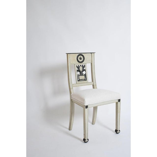 Neoclassical pineapple chairs, 1960s. Pair of chairs in grey and black lacquered wood, the openwork back decorated with a...