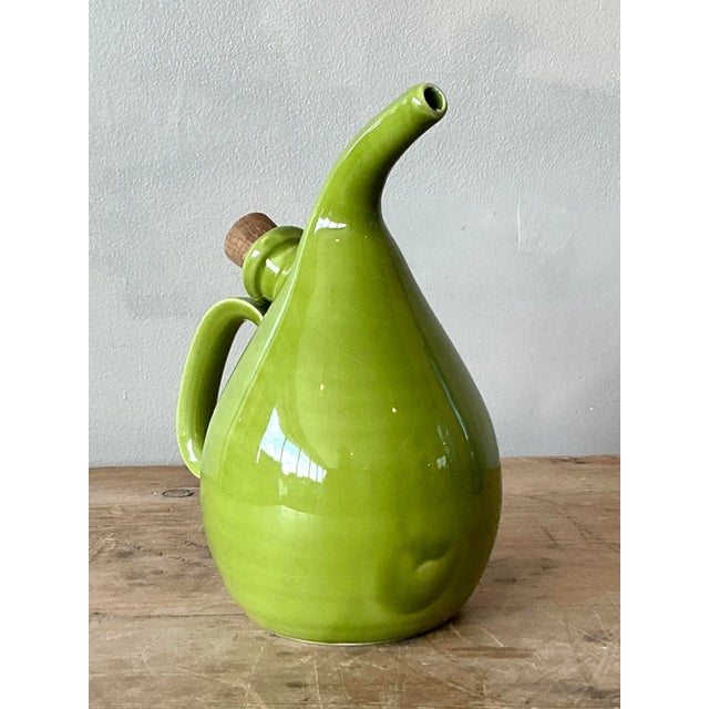 Presenting an authentic vintage Italian glazed ceramic olive oil pitcher, a charming and functional piece that brings...