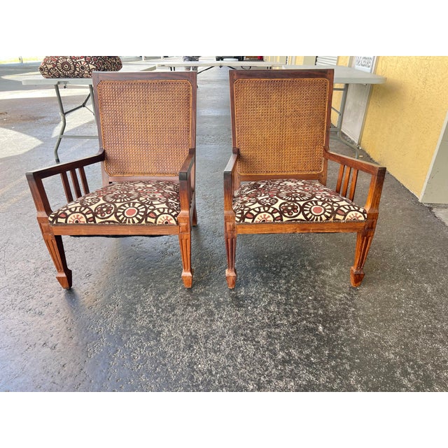 British Colonial Cane back Chairs with a Mission style. These chairs have a reupholstered seats with 2 pillows. The...