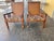 British Colonial Cane back Chairs with a Mission style. These chairs have a reupholstered seats with 2 pillows. The...