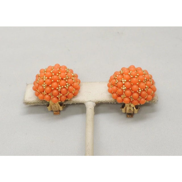 This is part of Chairish’s Costume Jewelry assortment. 1960s round goldtone pave cabochon pale orange faux-coral studded...