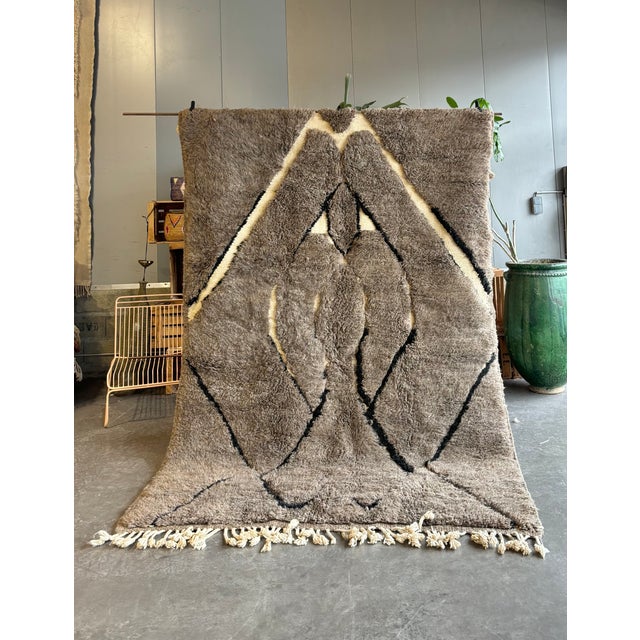 Elevate your interior with this authentic Moroccan Beni Ouarain rug, handwoven by skilled Berber artisans using 100%...