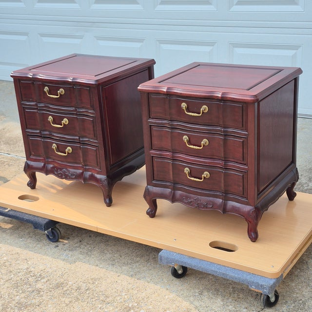 This is a pretty pair of vintage mahogany French provincial nightstands or end tables. The pieces are unsigned but likely...