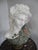 Antique, highly exclusive Carrara marble bust of a woman with a laurel wreath and grapes in her hair. The bust is crafted...