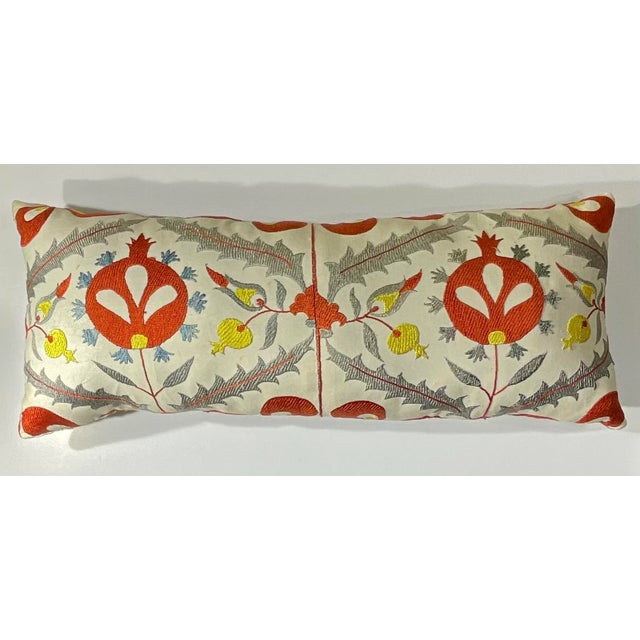 Bring a piece of Central Asian artistry into your home with this exquisite, hand-embroidered Suzani pillow. This unique...