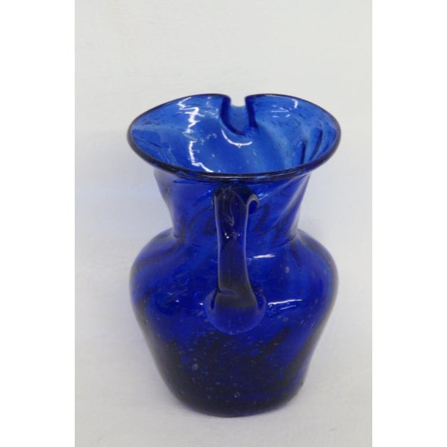 This gorgeous Small Pitcher / Creamer is made out of art glass. This darling miniature pitcher presents a beautiful style...
