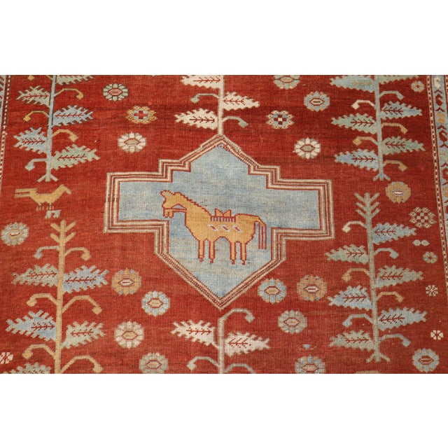 A geometric tribal looking Caucasian rug from the second quarter of the 20th century with saffron ground, accents in light...